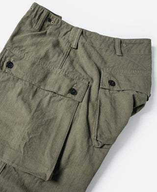 Olive utility cargo pants laid flat showing button fly and cargo pocket