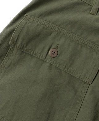 Olive cargo pocket flap with brown button on utility fatigue pants