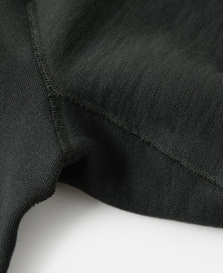 Dark raglan sleeve sweater hem with ribbed trim and knit texture detail