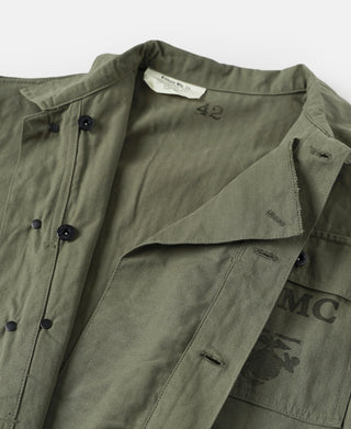Olive utility jacket interior with hanging label and open front panel