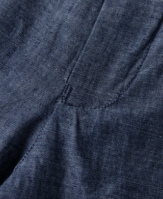 Indigo chambray pants back view close-up with pleats and seam stitching