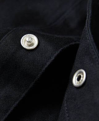 Black western shirt cuff button close-up with metal snaps on sleeve placket