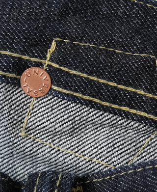 Indigo selvedge denim jeans showing rivet and yellow contrast seam on pocket