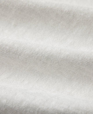 White knit henley T-shirt fabric close-up with fine textured weave