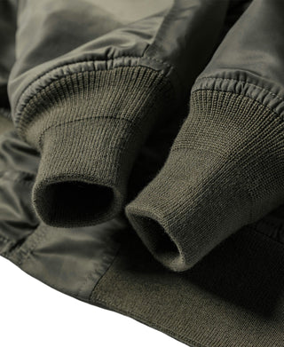 Olive bomber jacket sleeves with ribbed knit cuffs