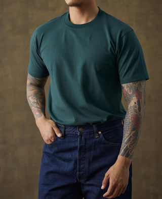 Dark green cotton crew-neck t-shirt on model with short sleeves