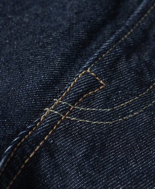 Indigo denim belt loop area with contrast golden topstitching