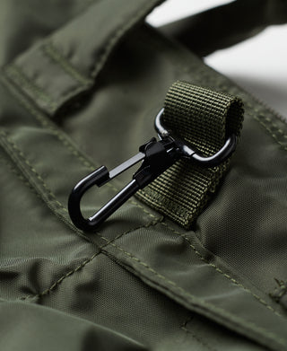 Olive nylon bag clasp and zipper track on pocket flap