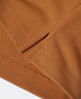 Close-up of orange sleeve cuff seam and stitching on the quarter-zip long-sleeve T-shirt