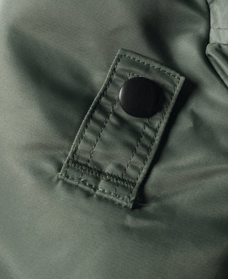 Olive MA-1 flight jacket, fabric tab with black snap and stitched square edge