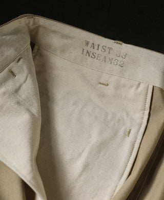Tan chino trousers with interior waistband label and partial back pocket