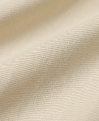 Apricot cotton T-shirt fabric close-up with smooth knit texture