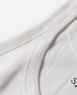 White cotton tank top chest seam detail with partial size text