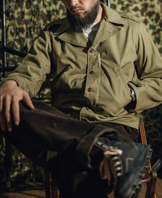 Olive green field jacket with button front and flap chest pocket