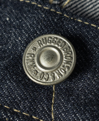 Indigo selvedge denim jeans, copper-toned logo button on dark denim