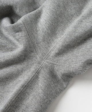 Hooded sweatshirt seam detail close-up, gray knit with V-gusset construction