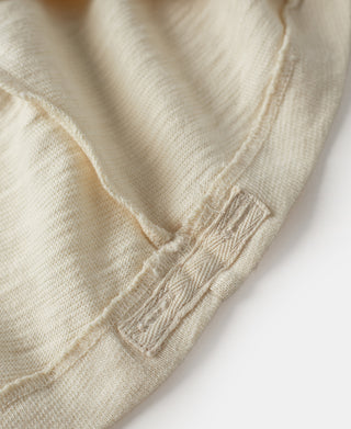Cream T-shirt sleeve cuff with stitched finish close-up