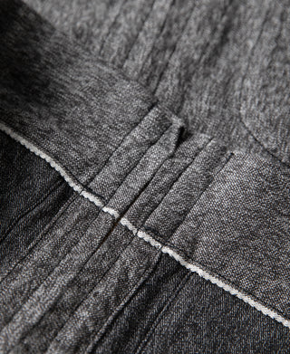 Salt & pepper cossack jacket seam close-up with contrast stitching and panel lines