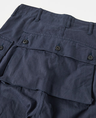 Navy utility shorts with layered cargo pocket flaps and metal snaps