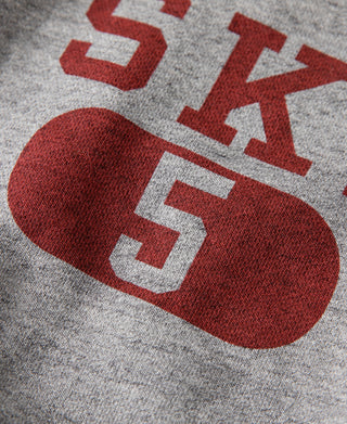 Gray sweater graphic close-up showing red “SKI” and “5” block