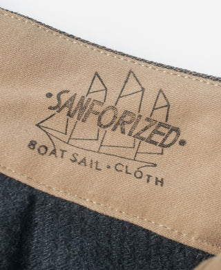 Brown striped pants fabric label reading “HAND FOR THE LONG RUN” and “100% OATS COTTON”
