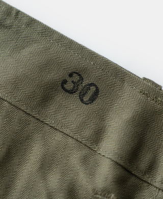 Olive trouser waistband with raised "30" marking and stitched fly
