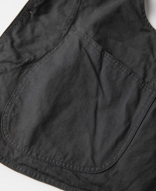 Dark green canvas vest interior pocket area with curved seam panel