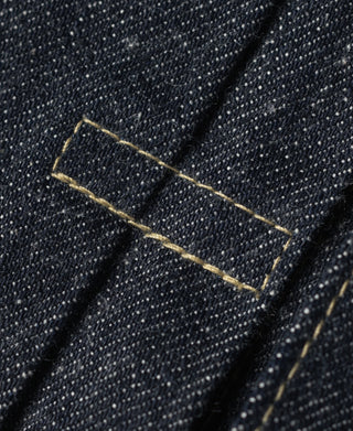 Indigo selvedge denim jacket, close-up of yellow-stitched seam