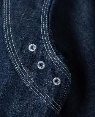 Indigo denim stitched shoulder reinforcement with two metal-look buttons