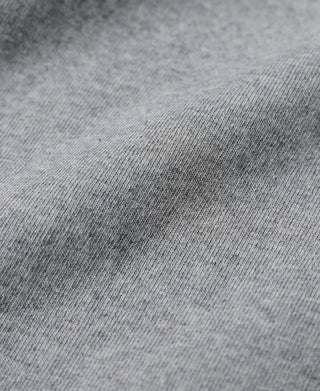 Gray cotton tubular T-shirt smooth knit fabric texture close-up.