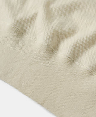 Light apricot waffle-knit T-shirt torso texture close-up