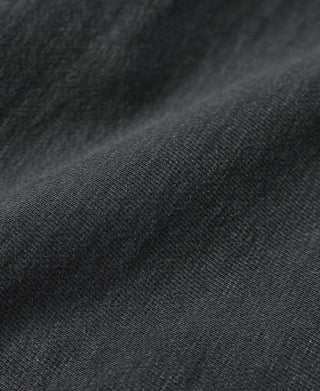 Black hoodie knit fabric close-up with textured weave