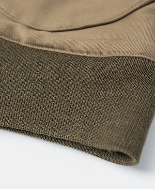 Khaki jacket hem with ribbed knit band and stitched seam