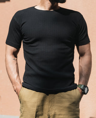 Black ribbed crewneck t-shirt worn by a model, short sleeves