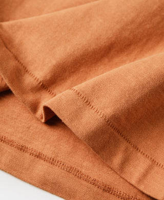 Orange t-shirt hem and sleeve cuff stitching detail.