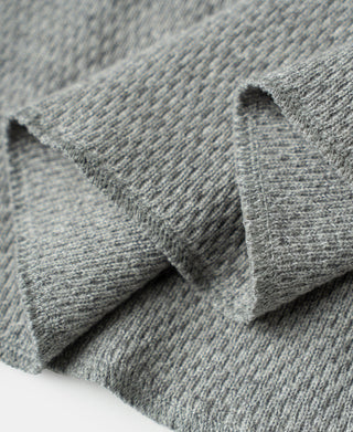 Gray waffle thermal knit sleeve cuff fold and stitching detail, close-up