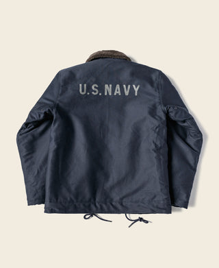 Navy deck jacket back with U.S. NAVY stencil text and fur-lined collar