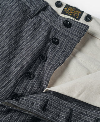 Black and gray striped pants with buttoned fly and stitched cuffs