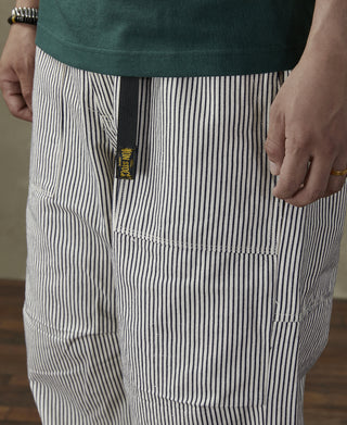 Striped pants with logo patch and cargo-style pockets, vertical dark-and-white pinstripes