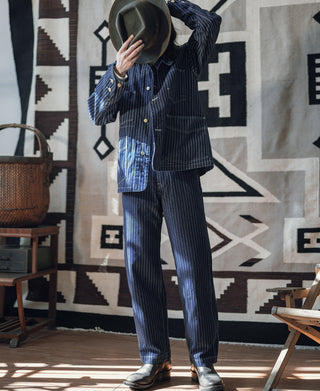 Indigo pinstriped railway work pants with straight legs and cuffed hem