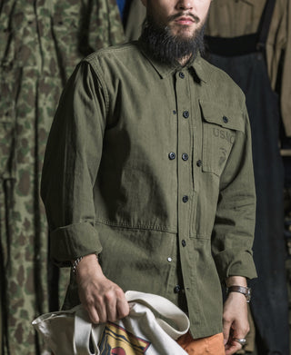 Olive utility jacket with stand collar, four-button placket, and flap chest pocket