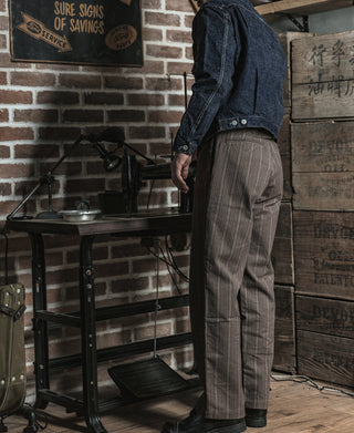 Brown pinstripe pants side view with belt loops and straight tapered leg