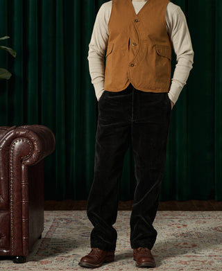 Black corduroy work pants full length on model, front pockets and belt loops