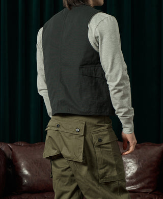 Dark green canvas vest with chest pocket, side view, V-neck, four buttons