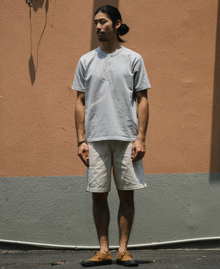 Gray henley T-shirt on model, short sleeves and three-button front, casual fit