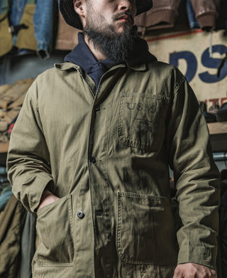 Olive utility jacket with button front, stand collar, and chest pocket