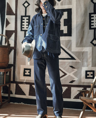 Indigo pinstripe work coat worn with matching striped work pants, button front