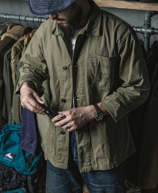 Olive utility jacket with flap chest pocket, button front, and long sleeves