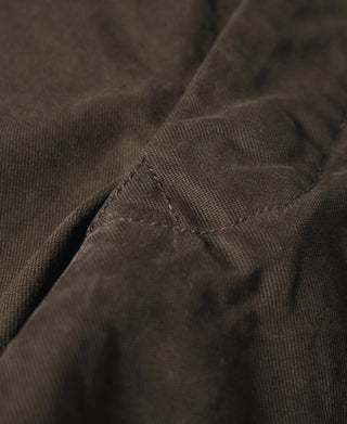 Brown combat pants pocket seam with reinforced stitching and fabric fold