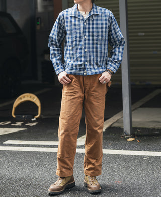 Blue plaid shirt jacket with camp collar and button front, styled with tan pants